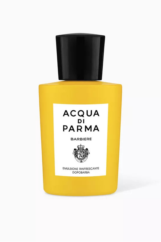 Yellow perfume bottle with black cap and white label on a white background