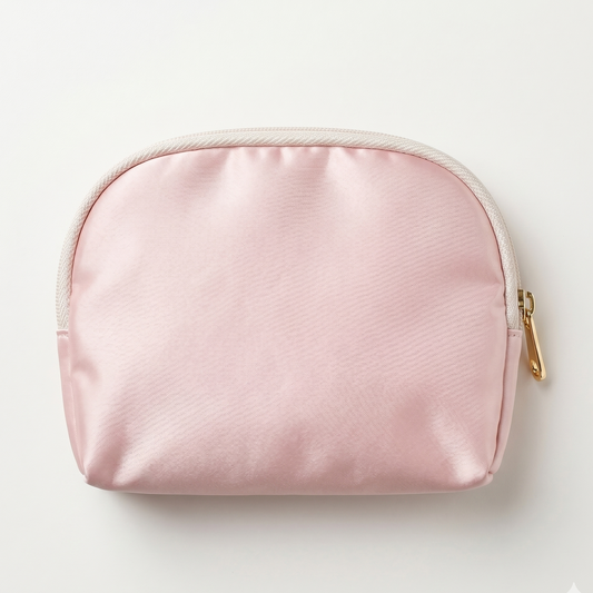 Pink cosmetic bag with gold zipper on a light gray background